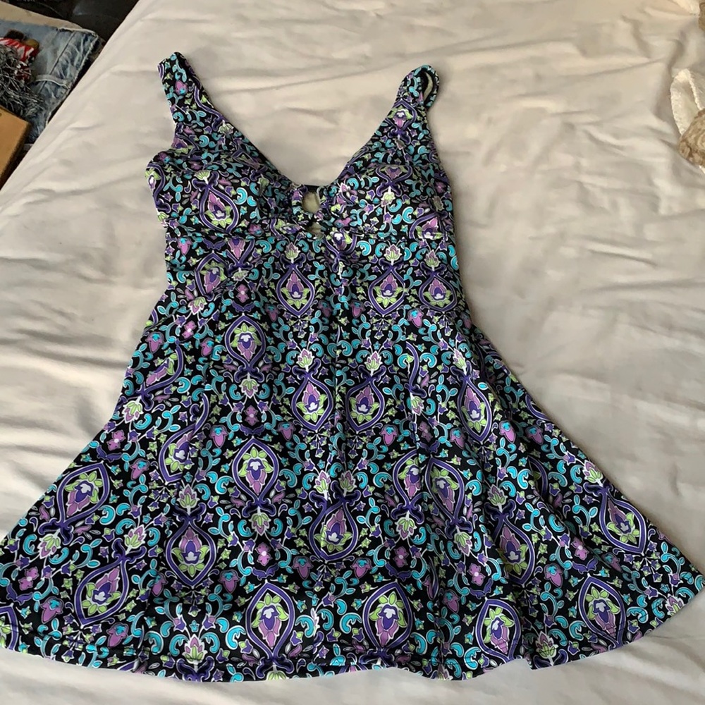 Floral one piece women’s swimsuit with skirted bottom. Beautiful colors